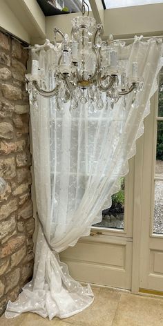 a chandelier hanging from the side of a window