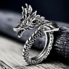 This intricately carved vintage Silver Dragon Ring exudes a touch of Gothic and Punk aesthetics. Crafted from 925 silver, this adjustable ring is a unique and timeless piece of men's jewelry. Perfect as a boyfriend gift or a versatile unisex gift option. *Vintage dragon ring *Adjustable *dragons are usually a goodwill symbol of fertility related to water and heaven. *This ring is stylish and pretty ideal for everyday use. * Gender : Male / Female *Ready to Ship in 1-2 Business Days * The product will be sent to you nicely packages and ready for gift giving. * Visit our store, browse other jewelry, silver, and gold collections, and find the perfect piece you're looking for. ♥️ Look and favorite my shop ♥️ ♥️ New Models every week ♥️ Punk Aesthetics, As A Boyfriend, Affordable Rings, Ancient Dragon, Vintage Dragon, Dragon Ring, Womens Rings Fashion, Dragon Head, A Boyfriend