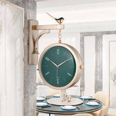 a clock hanging from the side of a wall in a dining room with yellow chairs