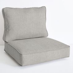 a gray chair with a pillow on it's back and seat cushion in the middle