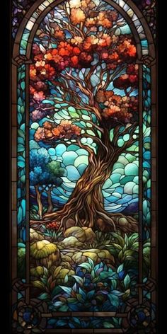 a stained glass window with an image of a tree in the center and leaves around it