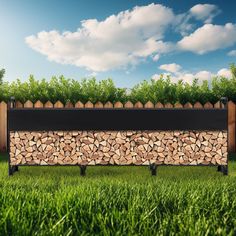 a bench made out of logs sitting in the grass