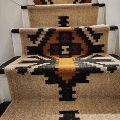 some stairs with carpet and rugs on them