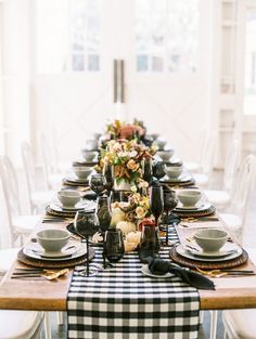 the table is set with black and white dishes