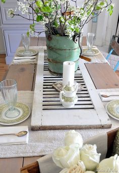 the table is set with flowers and plates