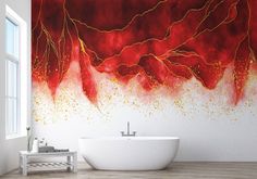 a bath tub sitting next to a wall with red and gold paint on the walls