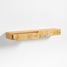 a wooden shelf that has some sort of object on it's back end and is made out of plywood