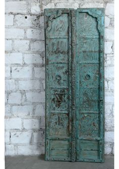 Experience the vintage elegance of Antique Teak Barn Doors from India, meticulously crafted from sturdy, reclaimed teak wood and finished in a beautifully weathered blue patina. These exterior doors exude vintage charm, with their distressed finish reflecting decades of history and character. The inherent strength of teak wood ensures not only their durability but also their ability to withstand the elements, making them ideal for enhancing the entrance to your home, garden, or patio. Whether us Antique Entryway, Textile Tapestry, Hindu Statues, Shabby Chic Interiors, Carved Doors, Rustic Blue, Antique Doors, Home Doors, Vintage Elegance