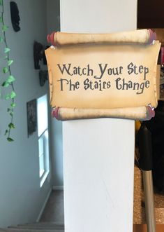 a sign that reads watch your step, the state change is hanging on a wall