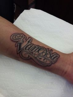 a person with a name tattoo on their arm