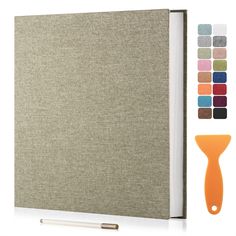 an open book with different colors on the cover and a pen next to it, along with color swatches