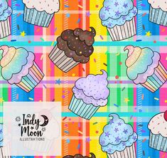 colorful cupcakes with icing and sprinkles on a plaid background