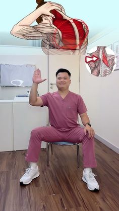 a man sitting in a chair with his hand up to the ceiling and an image of a woman hanging above him