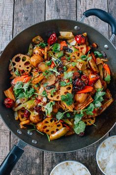 a pan filled with food on top of a wooden table