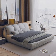 a large bed sitting in the middle of a living room next to a tall window