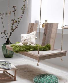 a living room filled with furniture and decor items in shades of green, brown, white and grey