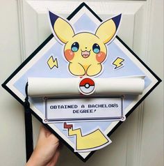 someone is holding up a pokemon themed graduation cap that says, obtain a bachelor's degree