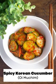 spicy korean cucumber in a white bowl with chopsticks next to it