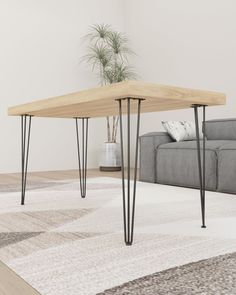 a living room with a gray couch and wooden table in the middle on carpeted flooring