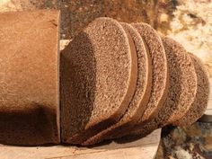 a loaf of bread sitting on top of a wooden cutting board