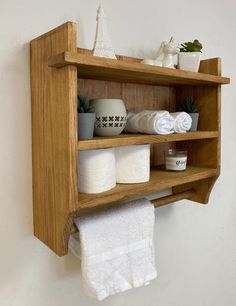 a wooden shelf with towels and other items on it