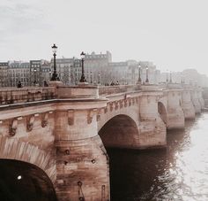 an old photo of a bridge over the water