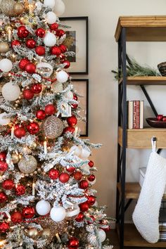 a decorated christmas tree with red, white and gold ornaments on it's branches