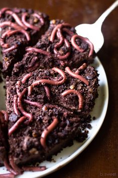 chocolate cake with red frosting on a white plate