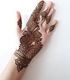 a hand with henna on it that is showing the intricate pattern and design,