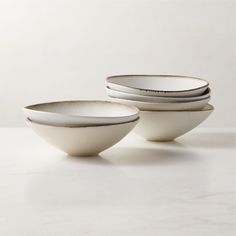 three white bowls stacked on top of each other