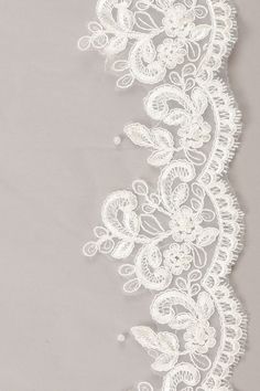 white lace with flowers on grey background