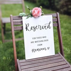 a sign that says reserved for those who are watching over from heaven on a wooden chair