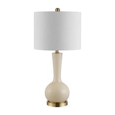 a table lamp with a white shade on the base and a gold metal frame around it