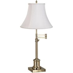 a lamp that is on top of a table with a white shade over the light