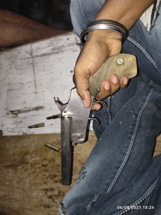 a man is holding a small knife in his hand