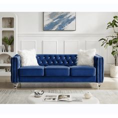 a blue couch with white pillows in a living room