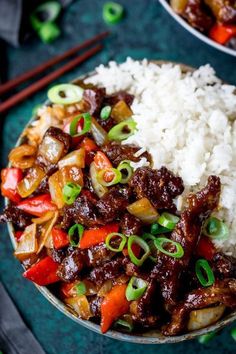 a bowl filled with rice, meat and vegetables