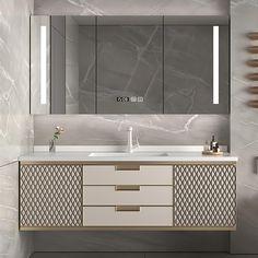 a bathroom vanity with two sinks, mirrors and lights on the wall above it is decorated in grey marble