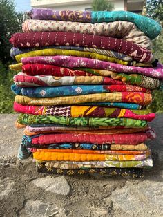 a stack of cloths sitting on top of a rock