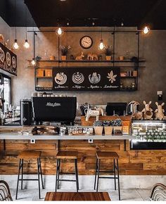 the interior of a coffee shop with wooden tables and chairs