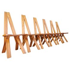 a long wooden rack with several pieces of wood hanging from it's sides on a white background