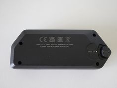 an electronic device is shown on a white surface with chinese characters in the back ground