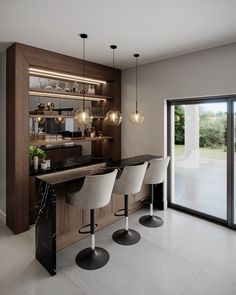 a kitchen with three bar stools next to an open glass door and sliding glass doors