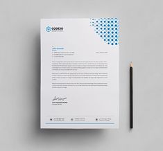 a white letterhead with blue dots on it and a pencil sitting next to it