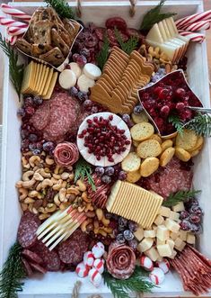 a platter filled with meat, cheese and crackers