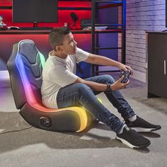 a man sitting in a gaming chair holding a game controller