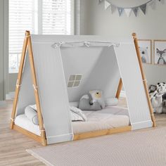 a child's bedroom with a tent bed and stuffed animals