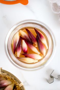 sliced onions in a glass bowl on a table