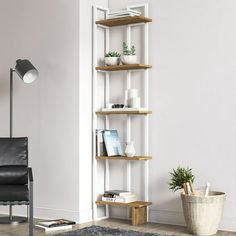 a living room filled with furniture and a book shelf next to a chair on top of a rug