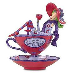 a figurine in the shape of a tea cup